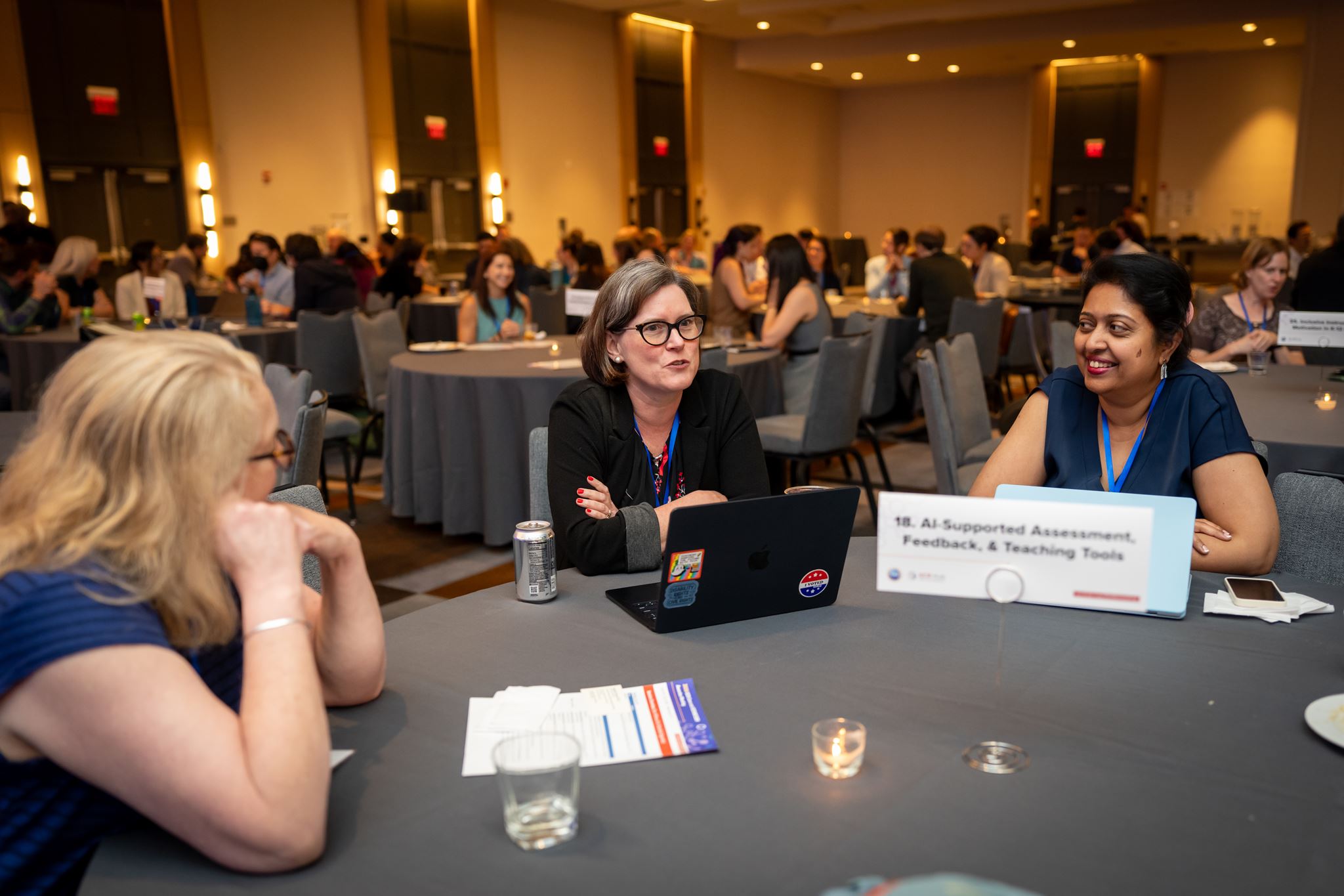 Three women sitting at a table. 