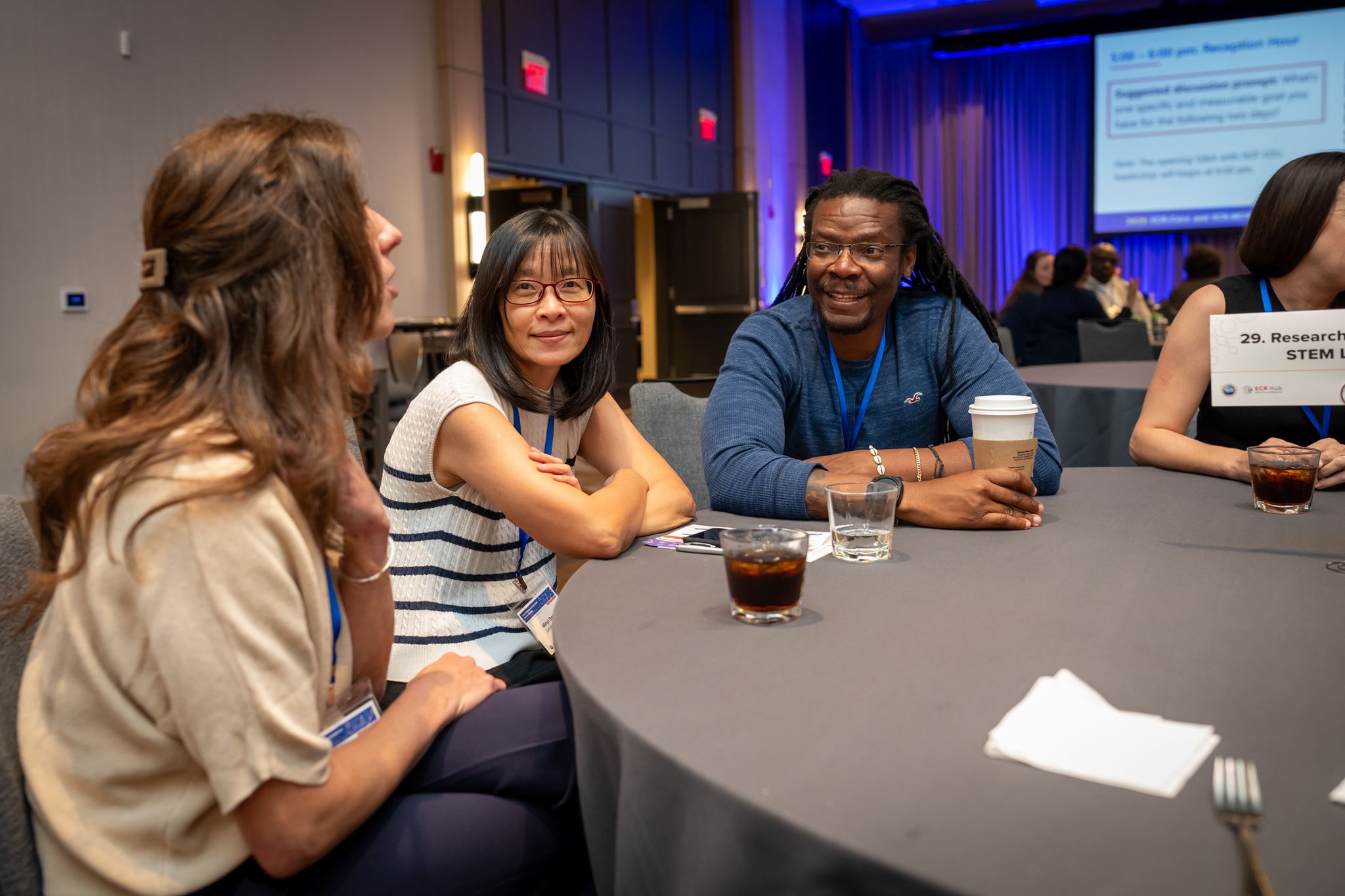 Three people sitting at a table at the meeting. 