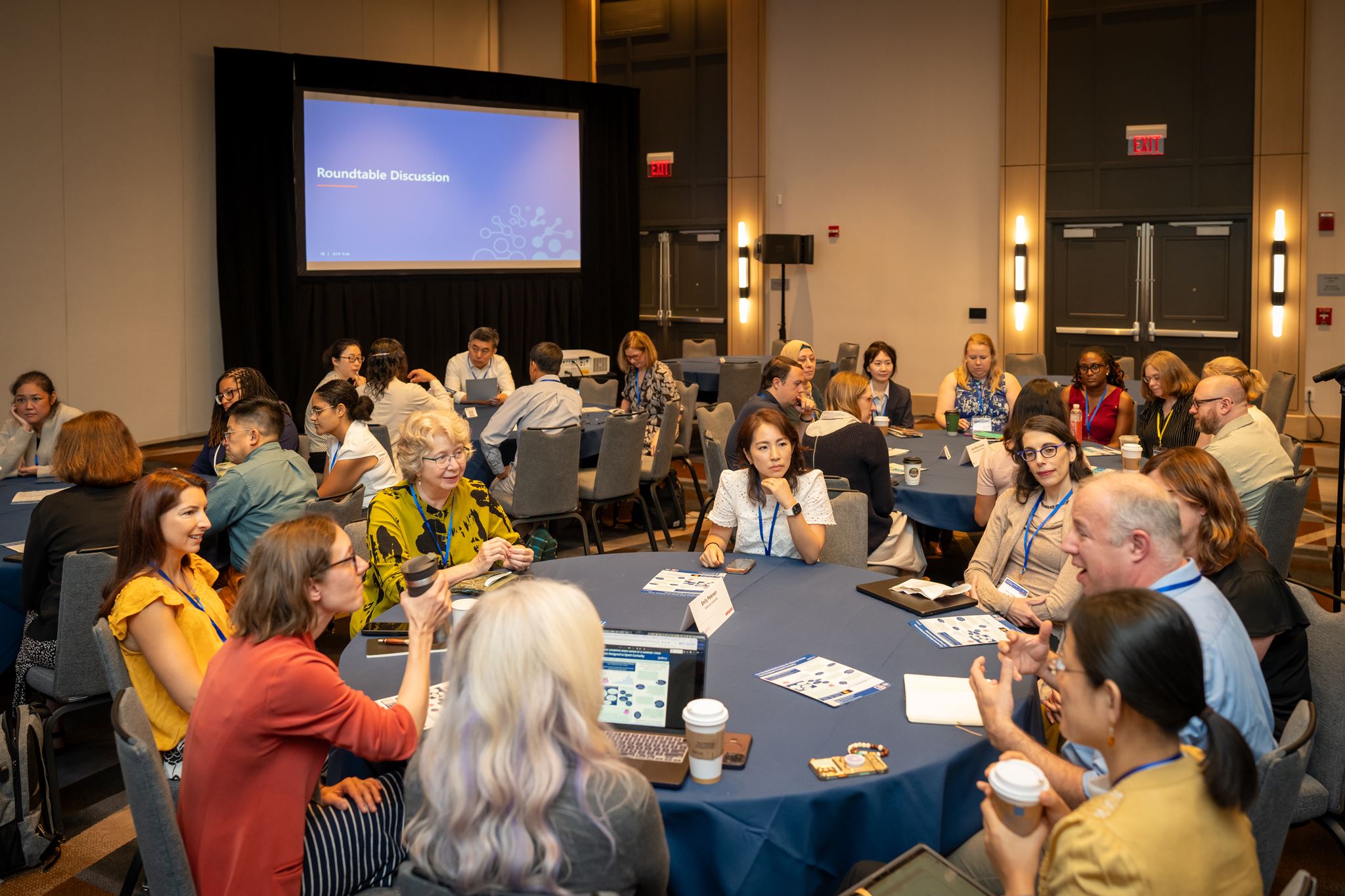 Several attendees sitting during a session