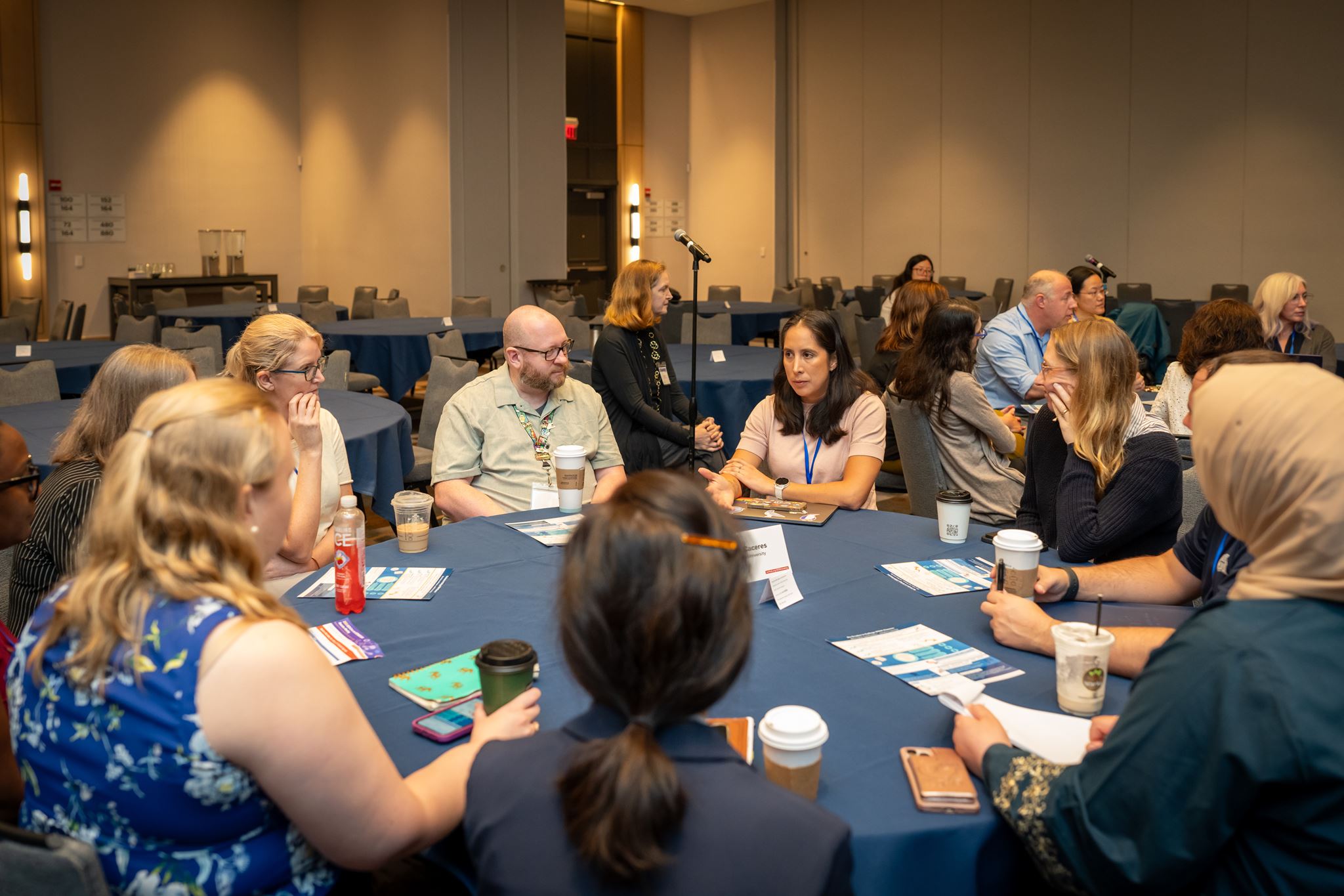 Multiple people sitting at the table in a discussion. 