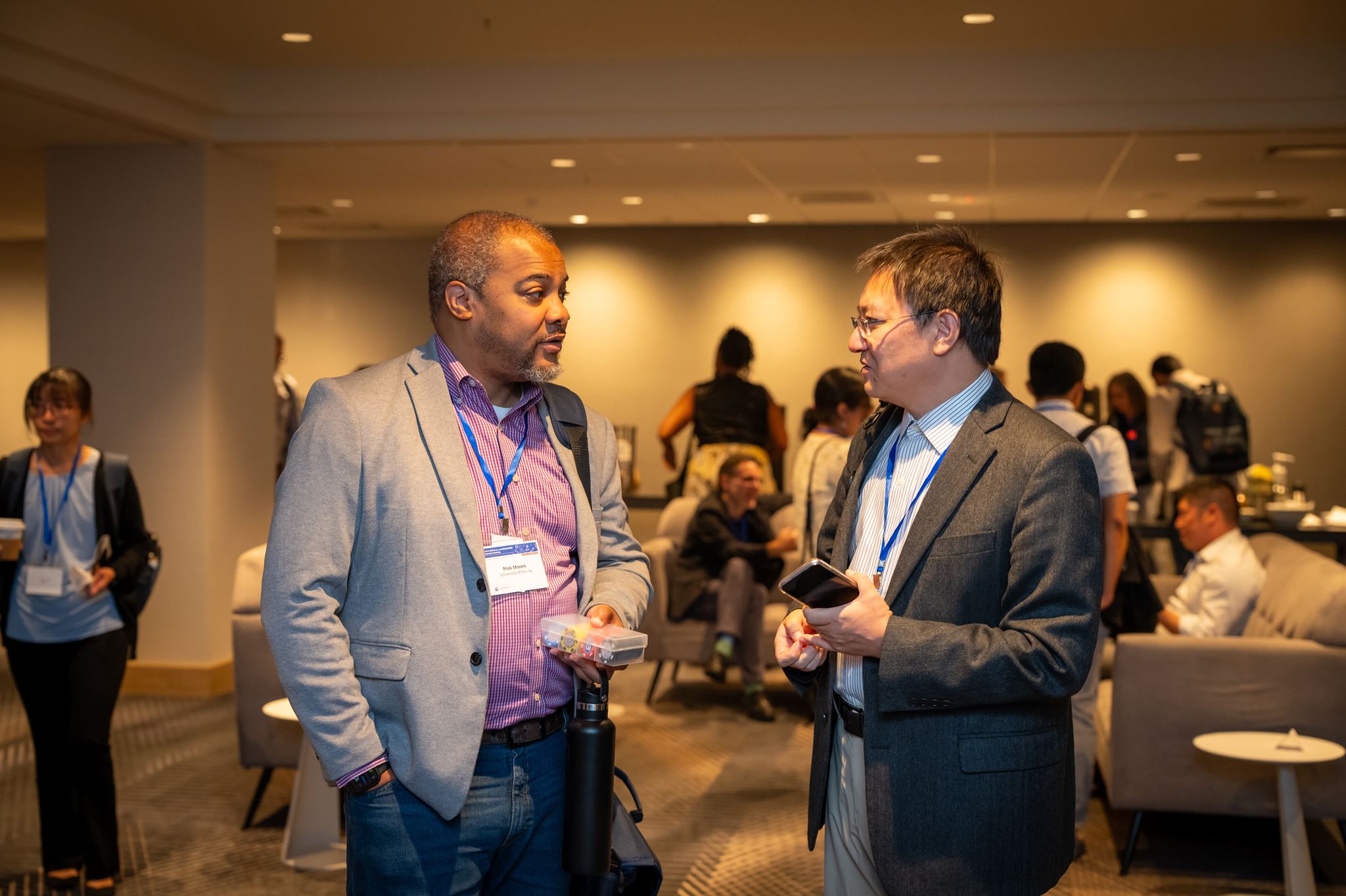 Two men standing and talking. 