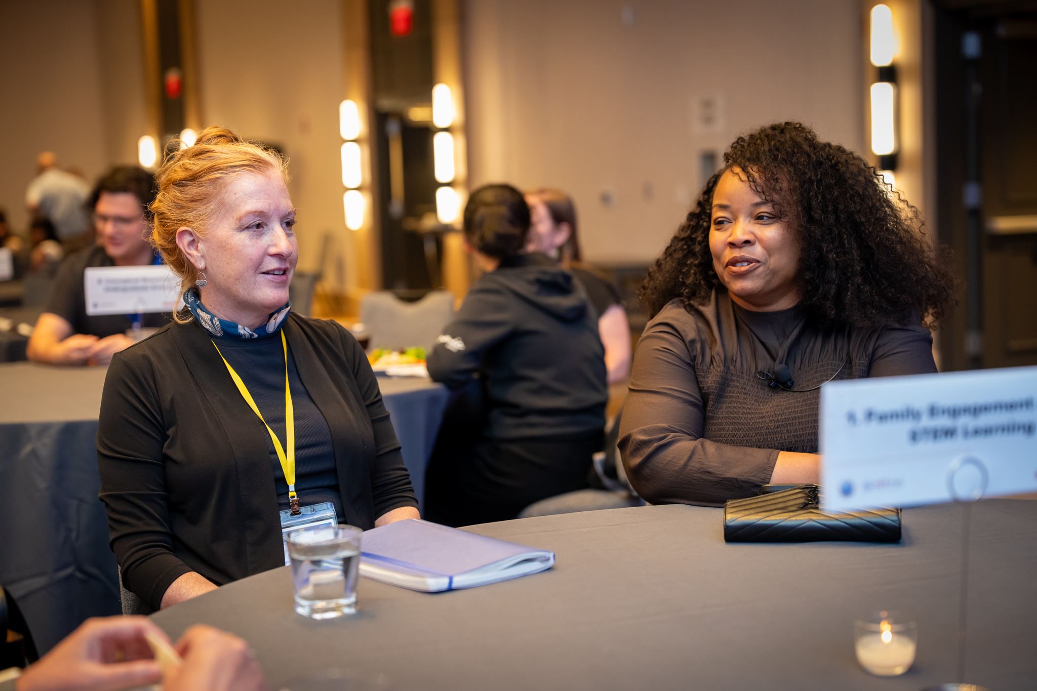 Two women sitting at a meeting table. 