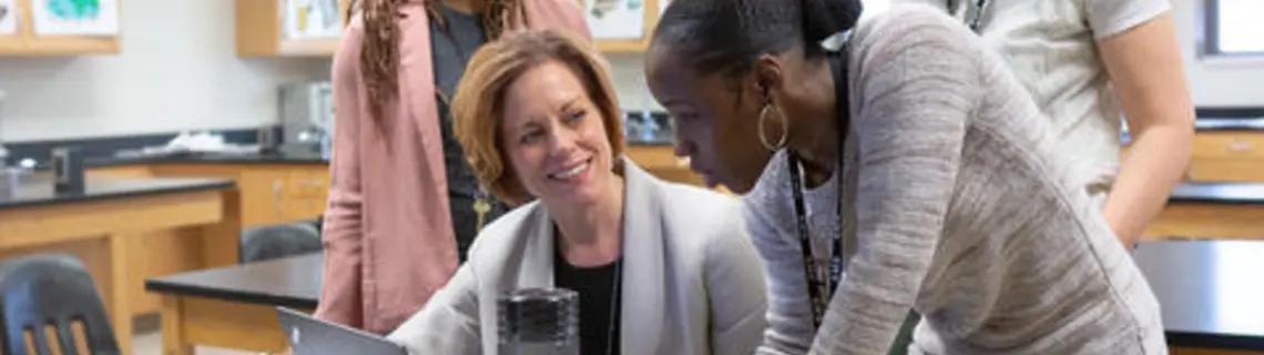teachers looking at a computer